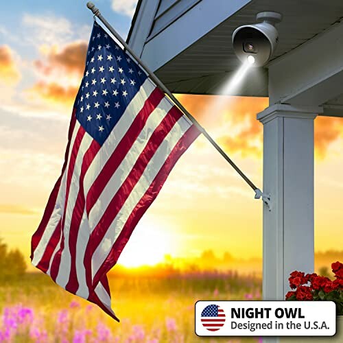 American flag and security camera on porch at sunset.