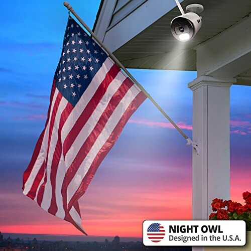 American flag near security camera on porch at sunset