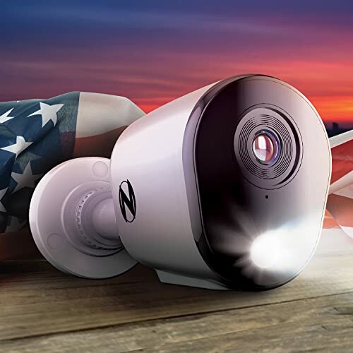 Security camera on wooden surface with American flag in background.