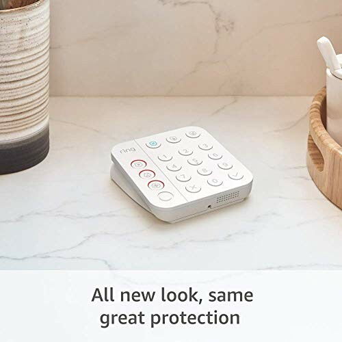 Smart home security keypad on a marble surface.