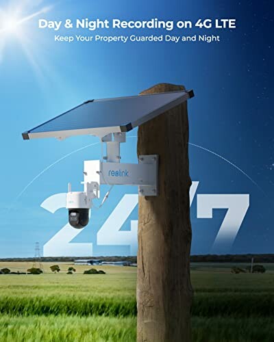 Solar-powered security camera mounted on a wooden post in a field.